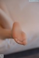 A close up of a baby's foot on a bed.