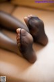 A close up of a person's feet in black stockings.