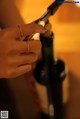 A person opening a bottle of wine with a corkscrew.