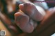 A close up of a baby's foot with a string attached to it.