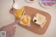 A person pointing at a piece of cake on a cutting board.